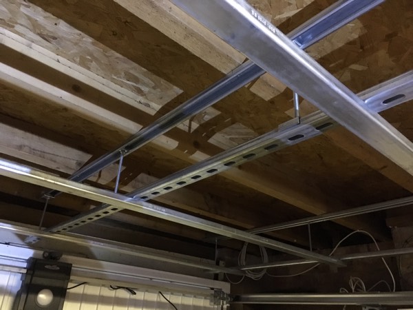 steel racking suspended from teh ceiling of a garage